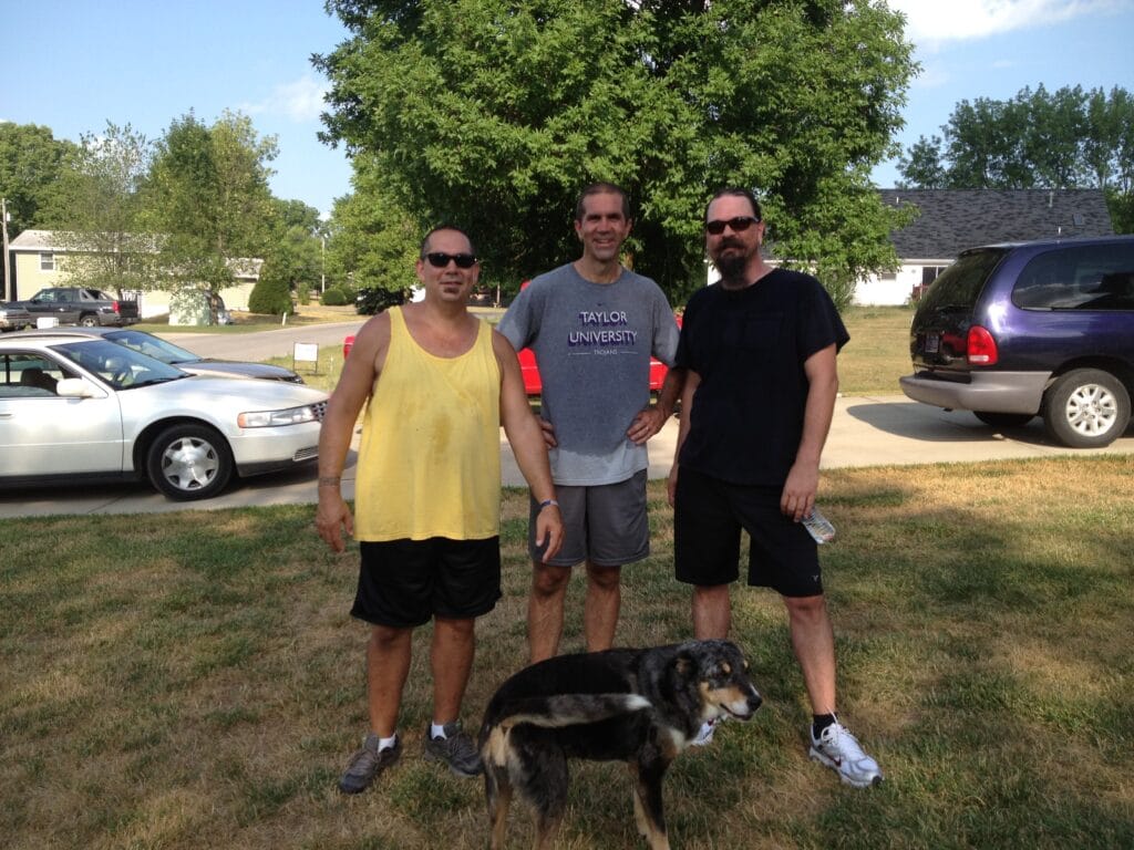 Three men standing on a lawn after completing a Labor Day 5K race in Indiana