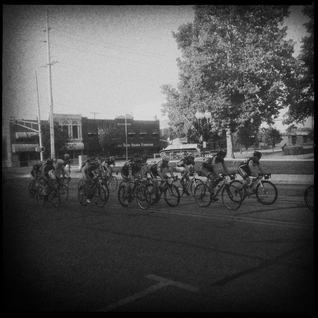 Peloton racing through downtown Warsaw Indiana during a criterium race